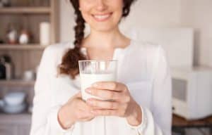 lady holding a glass of milk